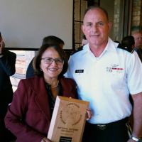 Congresswoman Jo Mores with a plaque  received from CAPSTONE Group.