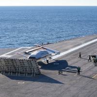 An MQ-25 Stingray test asset conducts deck handling maneuvers, including connecting to the catapult and clearing the landing area, while underway aboard USS George H.W. Bush (CVN -77). This unmanned carrier aviation demonstration marked the first time the Navy conducted testing with the MQ-25 at sea. (Boeing / Tim Reinhart)