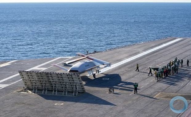 An MQ-25 Stingray test asset conducts deck handling maneuvers, including connecting to the catapult and clearing the landing area, while underway aboard USS George H.W. Bush (CVN -77). This unmanned carrier aviation demonstration marked the first time the Navy conducted testing with the MQ-25 at sea. (Boeing / Tim Reinhart)