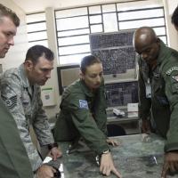 Members of the Brazilian Air Force point out specific landing zones for their aircraft during a tour on their squadron during a week-long exchange focused on enhancing Search and Rescue, May 15, 2015 in Campo Grande, Brazil. (U.S. Air Force photo by Staff Sgt. Adam Grant) 
